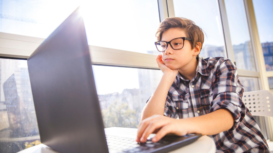 A young boy playing PG slot games